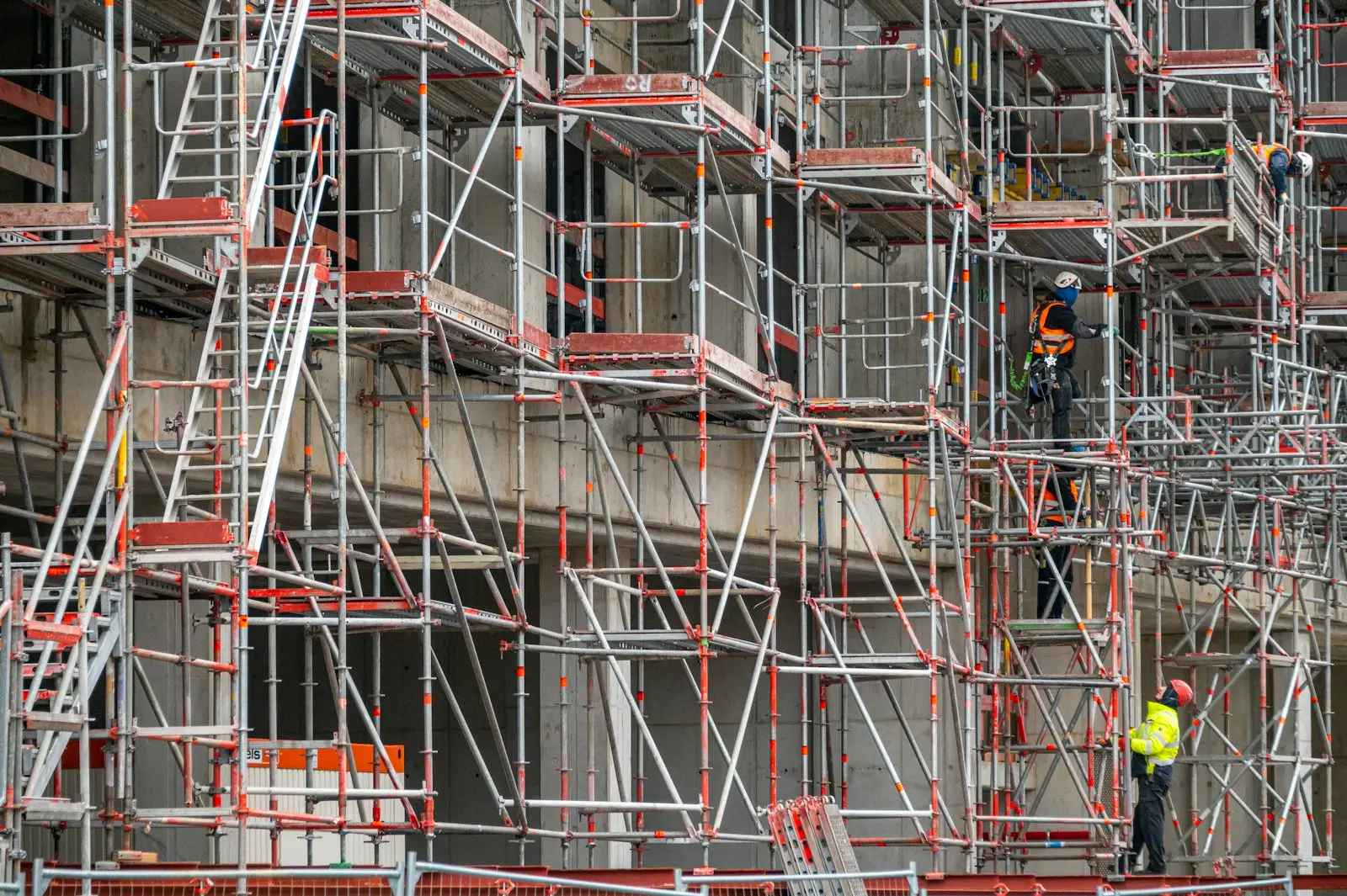 System scaffold on a large building with a crew in hi-vis